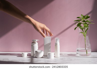 Hand is touching skincare set for cosmetic and beauty concept. - Powered by Shutterstock