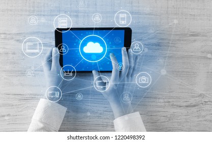 Hand touching tablet with cloud computing and online storage concept