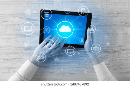 Hand touching tablet with cloud computing and online storage concept