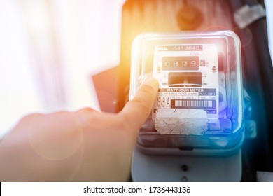 Hand Is Touching The Transformer With Copy Space.Incorrect Energy Detection Method.Watthour Meter Of Electricity For Use In Home Appliance.Electronics