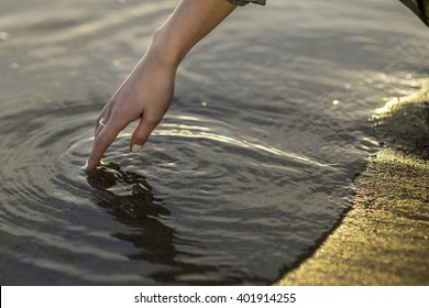 Hand Touching Water