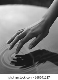 Hand Touching Water