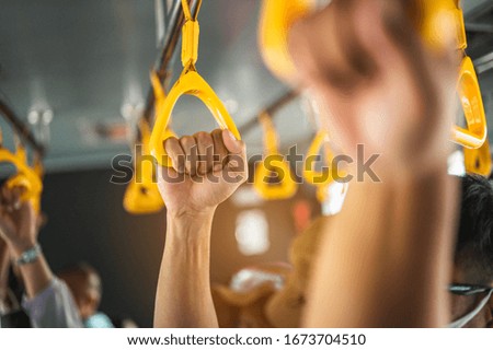 The hand of a tourist holding the handrail on the bus to get on the plane. Airplane, Travel, Hand, Airport, ticket, lifestyle concept.