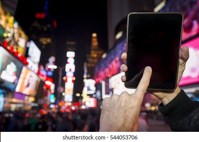 Hand Of A Tourist Touching A Blank Touchscreen Tablet In The Middle Of Times Square, New York City