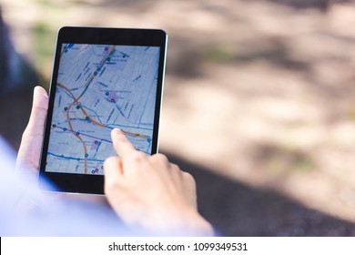 Hand of Tourists using navigation app or gps in the street searching locations on smartphone or digital tablet or consulting a city guide,copy space.  travel ,technology and lifestyle concept
