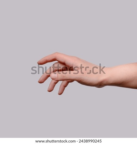 Hand trying to reach for someone or something. Gesture of asking help or sign for lust isolated on gray background. Carrying for you. Gentle motion and gesture female.