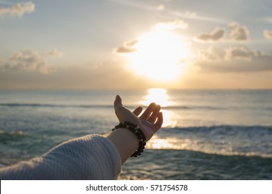 Hand trying to reach the sun