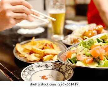 Hand trying to take food with disposable chopsticks - Powered by Shutterstock