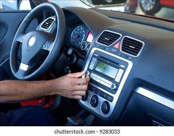 A Hand Tuning The Car Radio