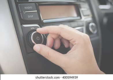 Hand Tuning Fm Radio Button In Car Panel. Retro Image Processed.