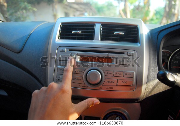 hand turn on the radio in
the car