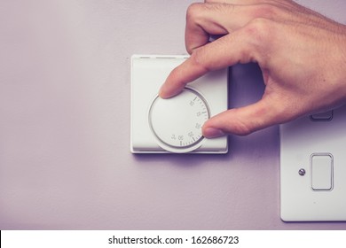 Hand Turning Dial On Thermostat