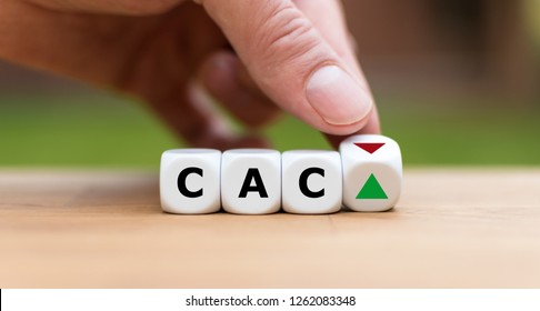 Hand is turning a dice and changes the direction of an arrow symbolizing that the CAC40 Index is changing the trend and goes up instead of down (or vice versa)