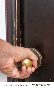 Hand Turning A Doorknob To Open Door