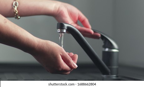 Hand Is Turning The Hot Running Water Flowing From Tap On And Off