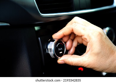 Hand turning knob Digital electronic dual heating and air conditioning system in automobiles with knob to regulate the temperature of the air entering through the fan.  dual zone car air conditioner - Shutterstock ID 2193342835