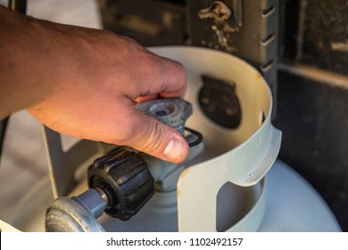 Hand Turning On Gas Propane Grill Tank Knob Close Up Grilling Off Twisting