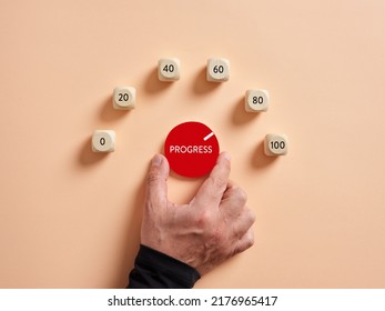 Hand turning progress level meter indicating high level of progression. Progress and performance growth or increase concept.