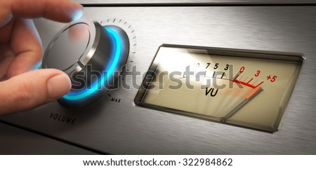 Hand turning the volume knob of an amplifier up to the maximum, Concept image for noisy environment or hearing problems