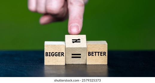 Hand turns cube and changes an equal sign to an unequal sign. Symbol that bigger is not necessarily better.