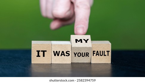 Hand turns cube and changes the expression 'it was your fault' to 'it was my fault'.
