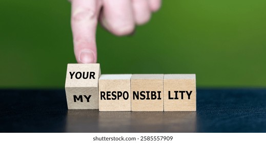 Hand turns cube and changes the expression 'my responsibility' to 'your responsibility'.