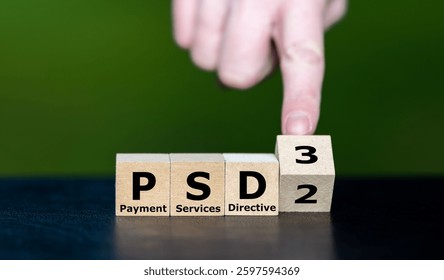 Hand turns cube and changes the expression PSD2 (Payment Services Directive 2) to PSD3 (Payment Services Directive 3).