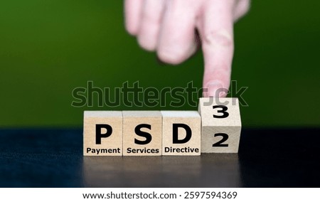 Hand turns cube and changes the expression PSD2 (Payment Services Directive 2) to PSD3 (Payment Services Directive 3).