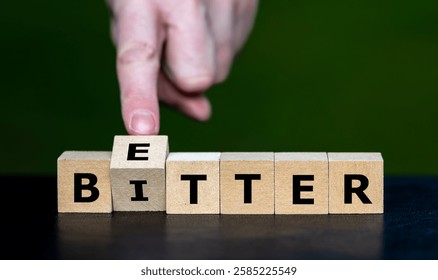 Hand turns cube and changes the word bitter to better.