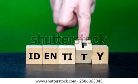Hand turns cube and changes the word identity to identify.