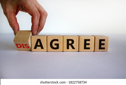 Hand turns a cubes and changes the expression 'disagree' to 'agree'. Beautiful white background. Business concept, copy space.