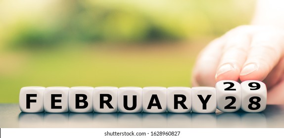 Hand turns dice and changes the date from "February 28" to "February 29". - Shutterstock ID 1628960827