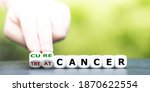 Hand turns dice and changes the expression "treat cancer" to "cure cancer".