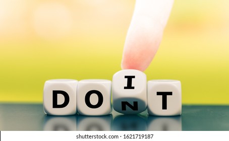 Hand turns a dice and changes the expression "don't" to "do it".