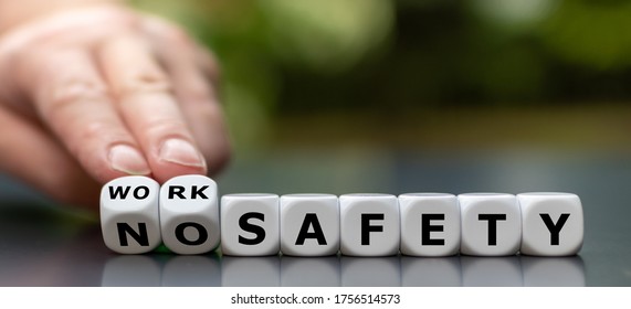 Hand turns dice and changes the expression "no safety" to "work safety".