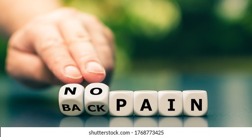 Hand turns dice and changes the expression "back pain" to "no pain". - Shutterstock ID 1768773425