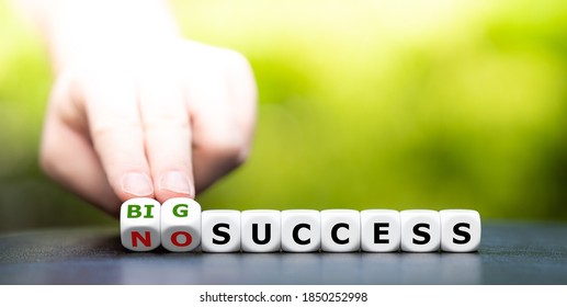 Hand turns dice an changes the expression "no success" to "big success". - Shutterstock ID 1850252998
