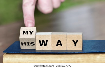 Hand turns dice and changes the expression 'his way' to 'my way'.