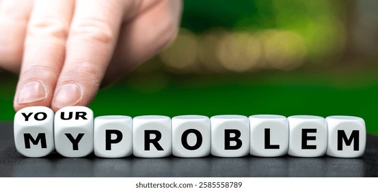 Hand turns dice and changes the expression 'my problem' to 'your problem'.