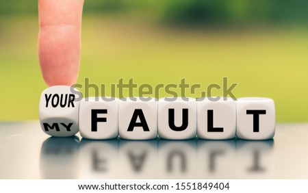 Hand turns a dice and changes the expression "my fault" to "your fault", or vice versa.