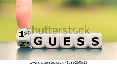 Hand turns a dice and changes the expression "2nd guess" to "1st guess", or vice versa.
