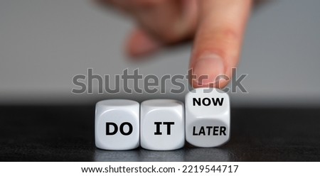 Hand turns dice and changes the expression 'do it later' to 'do it now'.