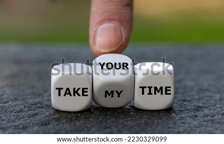 Hand turns dice and changes the expression 'take my time' to 'take your time'.