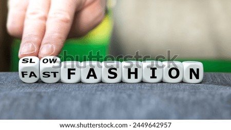 Hand turns dice and changes the expression 'fast fashion' to 'slow fashion'.
