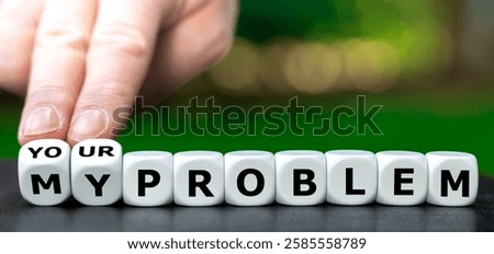 Hand turns dice and changes the expression 'my problem' to 'your problem'.