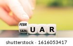 Hand turns a dice and changes the German word "Januar" ("January" in English) to "Februar" ("February" in English).