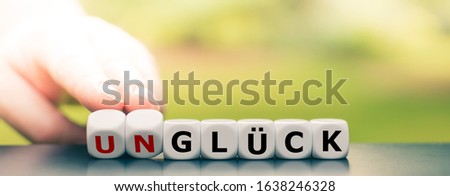 Hand turns dice and changes the German word 
