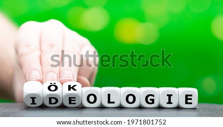 Hand turns dice and changes the German word 