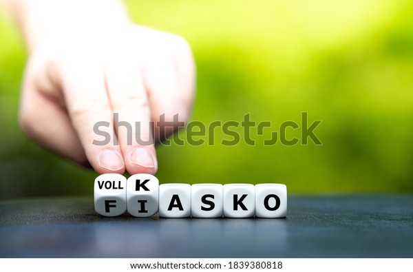 Hand turns dice\
and changes the German expression \