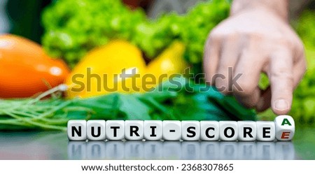 Hand turns dice and changes the Nutri-score from E to A. Symbol for a healthier life.